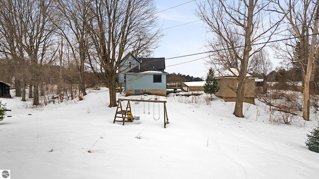 yard covered in snow featuring a garage