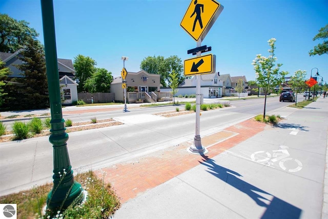 view of road with sidewalks and traffic signs