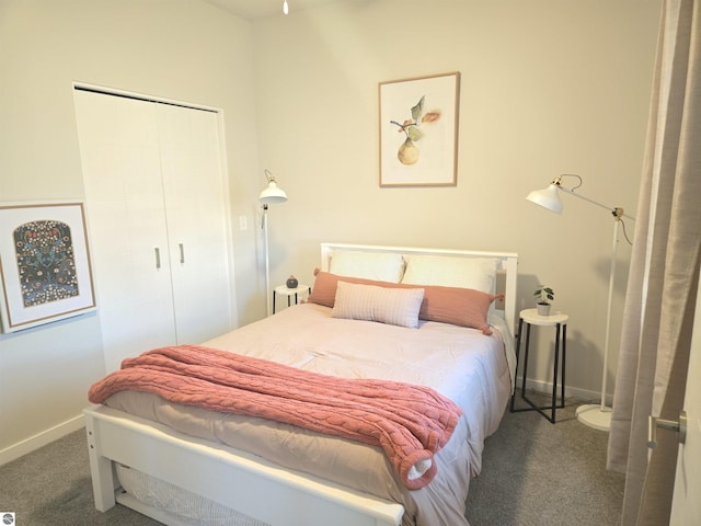 carpeted bedroom featuring a closet and baseboards