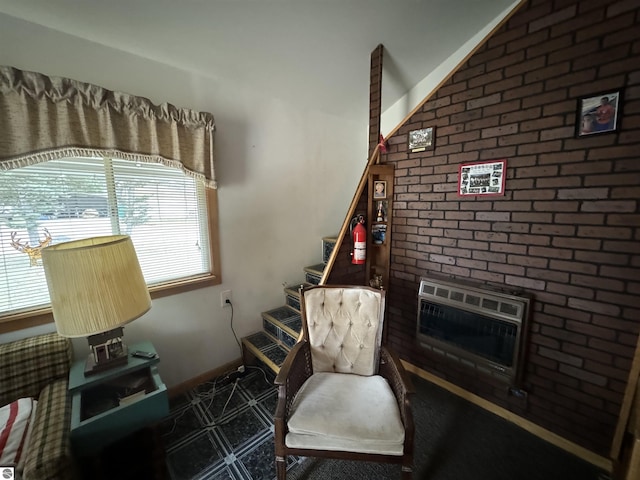 sitting room featuring baseboards, a fireplace, and heating unit