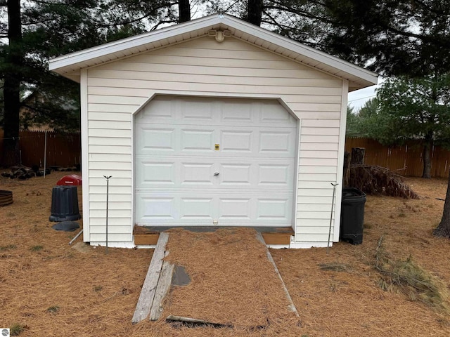 detached garage featuring fence