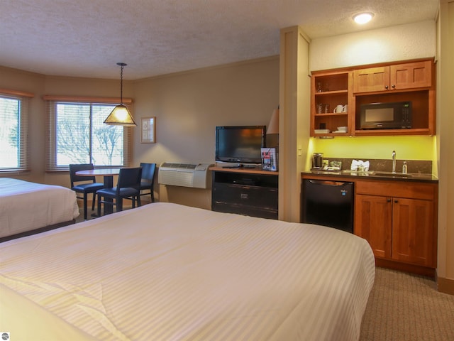 bedroom featuring light carpet, refrigerator, wet bar, a textured ceiling, and a sink