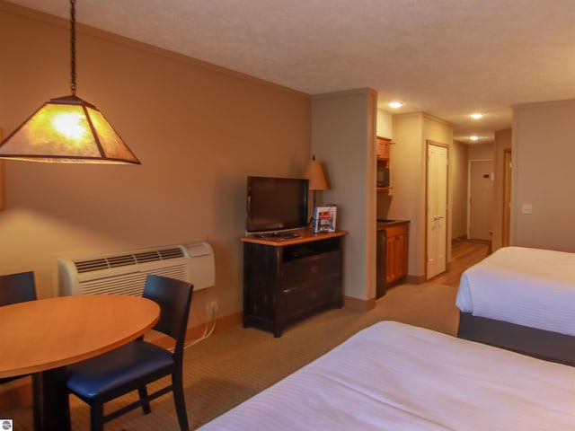 bedroom featuring crown molding, baseboards, and a wall mounted AC