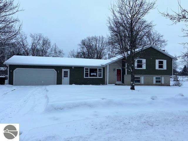 view of front of home featuring an attached garage and brick siding