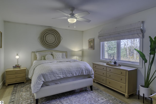 bedroom with ceiling fan and light wood-style flooring