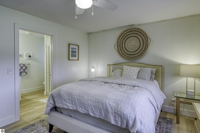 bedroom with ceiling fan, baseboards, and wood finished floors