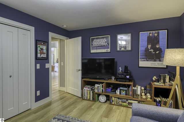 living room with baseboards and wood finished floors