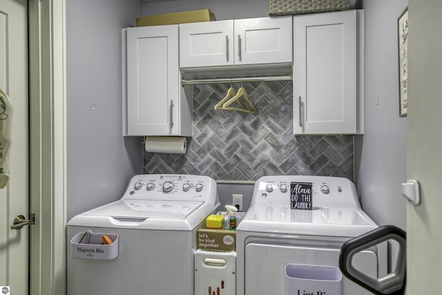 clothes washing area with cabinet space and washing machine and clothes dryer