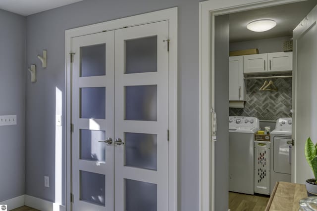 doorway with wood finished floors and washer and dryer