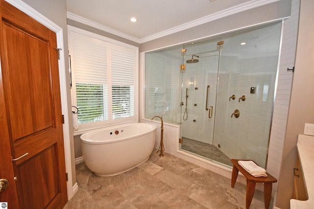 bathroom with crown molding, a shower stall, a freestanding bath, and vanity