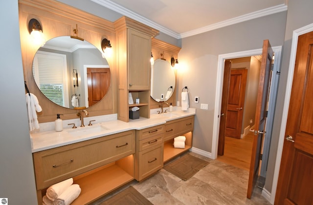 bathroom featuring double vanity, crown molding, and a sink