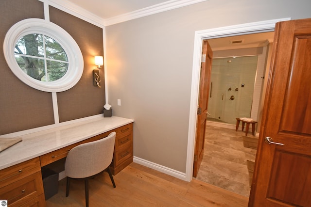 office with baseboards, ornamental molding, and light wood-style floors