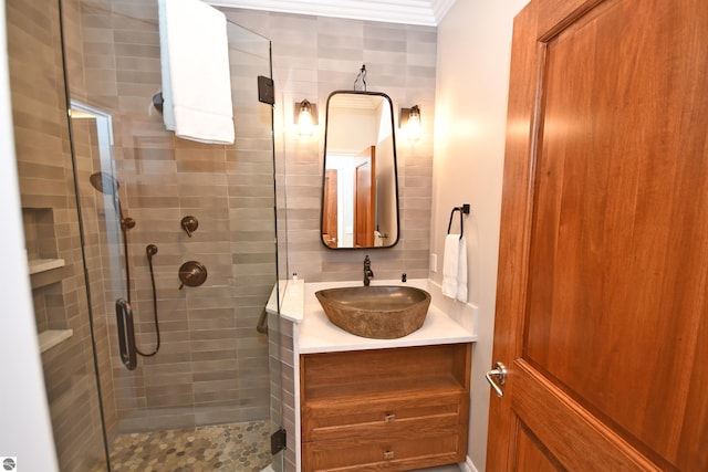 bathroom with ornamental molding, a stall shower, and vanity