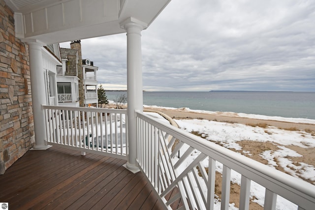 deck with a beach view and a water view