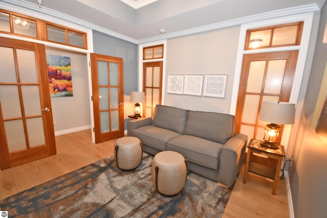 living area featuring french doors, wood finished floors, and baseboards