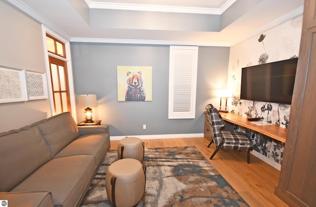 living room with baseboards, ornamental molding, and wood finished floors