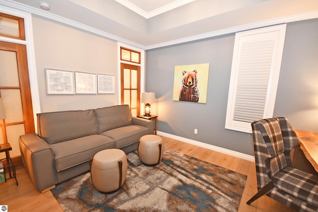 living room with baseboards, wood finished floors, and crown molding