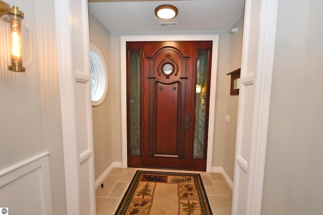 entrance foyer featuring visible vents, baseboards, and light tile patterned floors