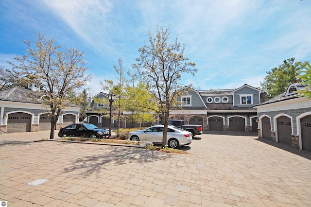 view of front of property with stone siding and decorative driveway