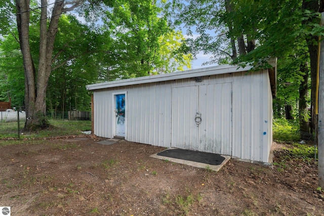 view of outbuilding with an outbuilding and fence