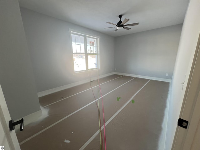 spare room featuring baseboards and a ceiling fan