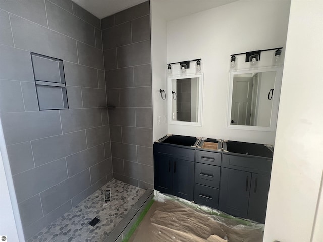 full bathroom with double vanity and a stall shower