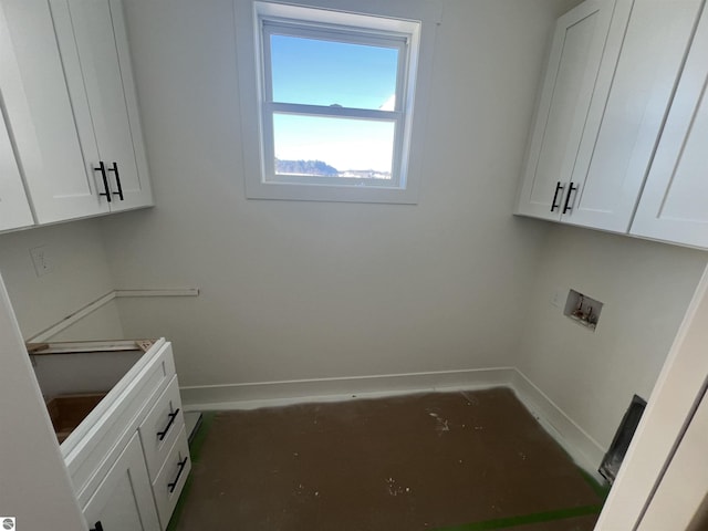 laundry room with hookup for a washing machine and baseboards