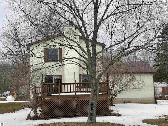 snow covered property featuring a deck