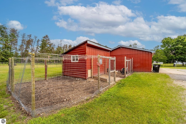 view of outbuilding featuring an outbuilding and fence