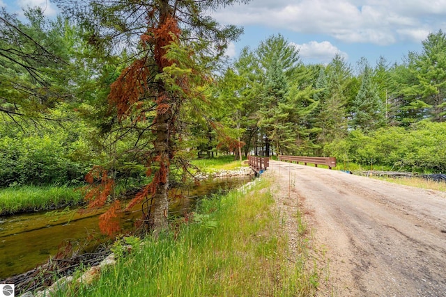 view of road featuring a forest view