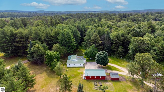 birds eye view of property with a view of trees