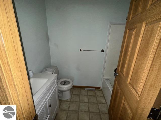 bathroom with visible vents, vanity, toilet, and baseboards