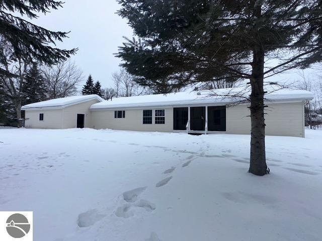 snow covered property featuring a garage