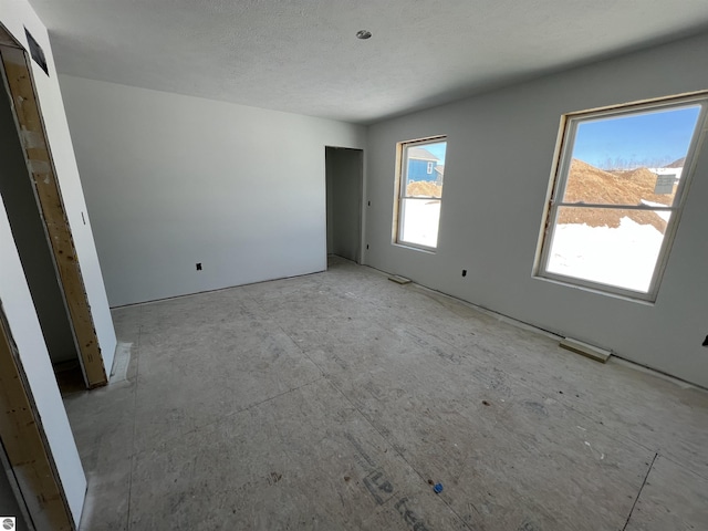 unfurnished bedroom featuring visible vents and a textured ceiling