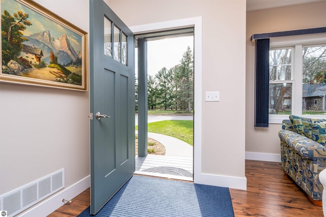 entryway with baseboards, wood finished floors, and visible vents