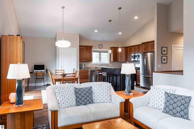 living room with recessed lighting, light wood-style floors, and high vaulted ceiling