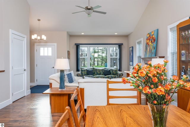 living room featuring ceiling fan with notable chandelier, vaulted ceiling, wood finished floors, and recessed lighting