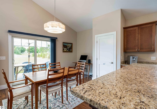 dining area with wood finished floors, lofted ceiling, and baseboards