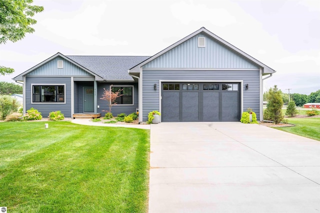 modern inspired farmhouse featuring a garage, driveway, roof with shingles, board and batten siding, and a front yard