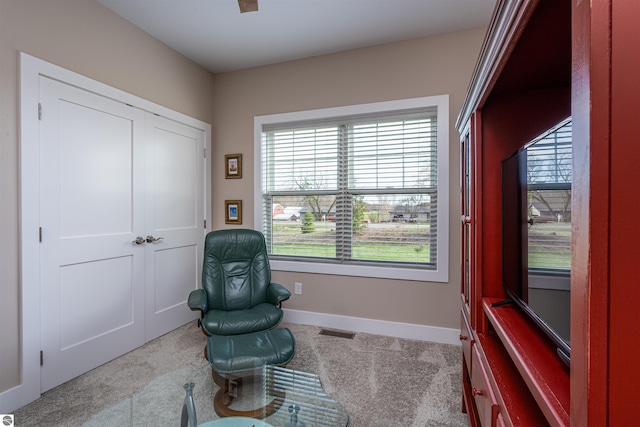 living area featuring carpet, visible vents, and baseboards