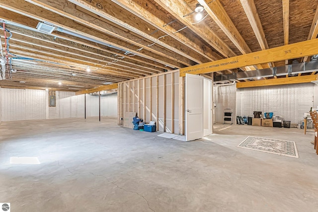 unfinished basement featuring electric panel
