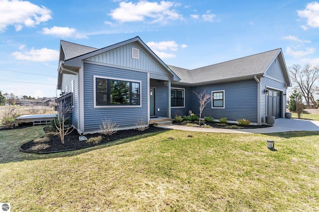 ranch-style house featuring board and batten siding, an attached garage, a front lawn, and driveway