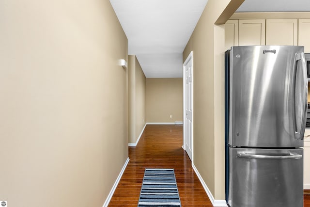 hall featuring dark wood finished floors and baseboards