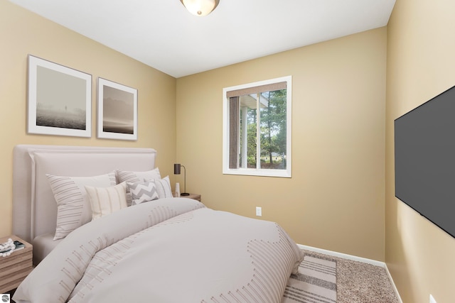 bedroom featuring carpet floors and baseboards