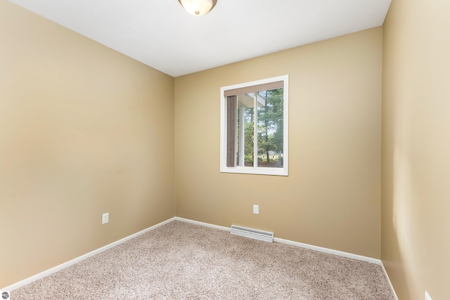 carpeted spare room with baseboards and visible vents