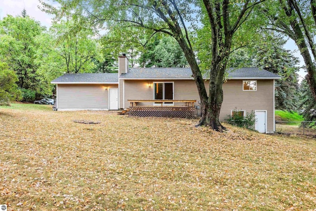 view of front of home featuring a deck, a chimney, and fence