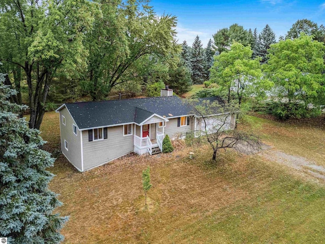 single story home with roof with shingles, driveway, and a chimney