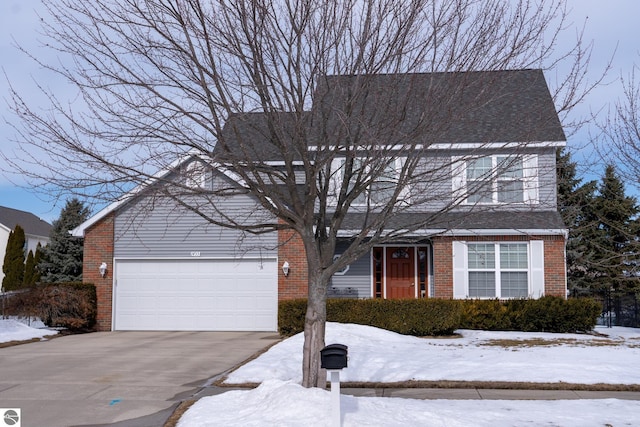 view of front of home with concrete driveway, brick siding, and an attached garage