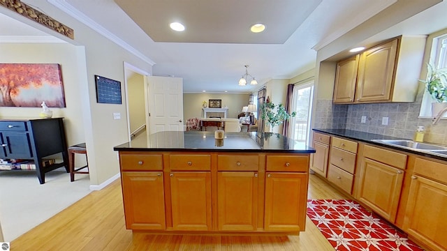 kitchen with dark countertops, tasteful backsplash, and ornamental molding