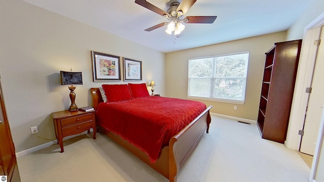 bedroom featuring light carpet, baseboards, visible vents, and ceiling fan